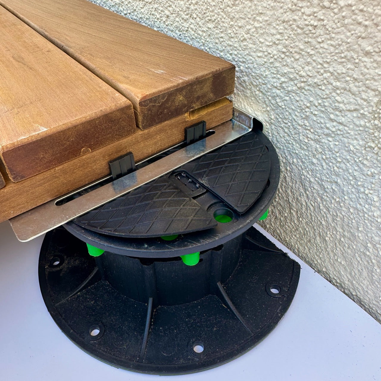 Perimeter clip for pedestal deck tile installation against wall